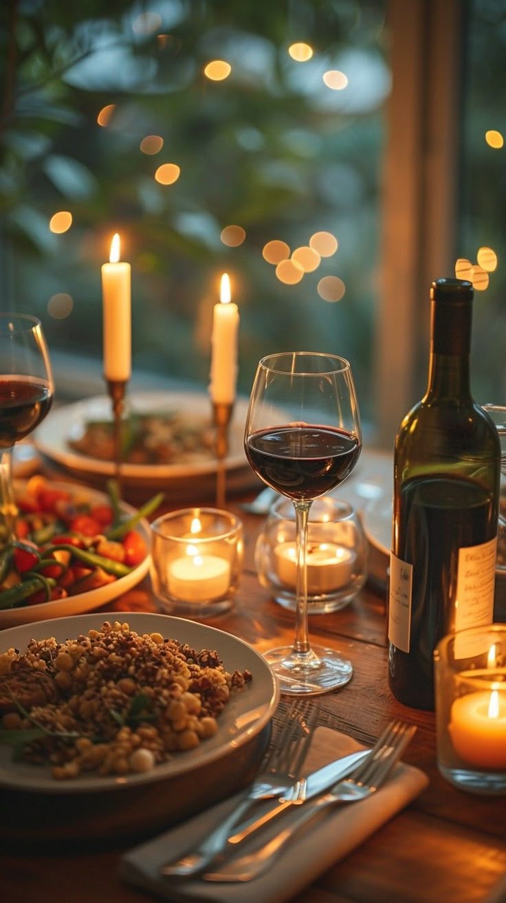 Candlelit dinner for two with wine, roasted vegetables, and glowing taper candles